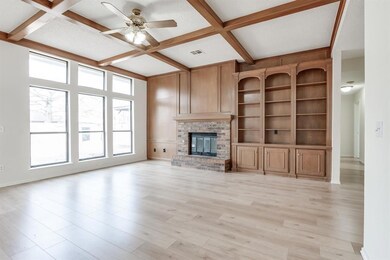 Unfurnished living room with a fireplace, beamed c