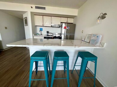 Kitchen with kitchen peninsula, white cabinets, st