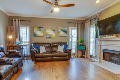 Large living room with hardwoods, updated lighting and crown moldings throughout.