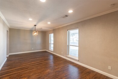 Dedicated dining area with natural light streaming through large windows, perfect for family meals or entertaining.