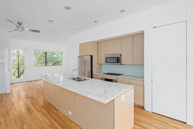 Kitchen featuring ceiling fan, a center island wit