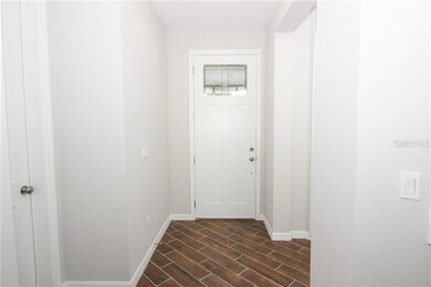 What a warm and inviting foyer entrance with a grand front door.