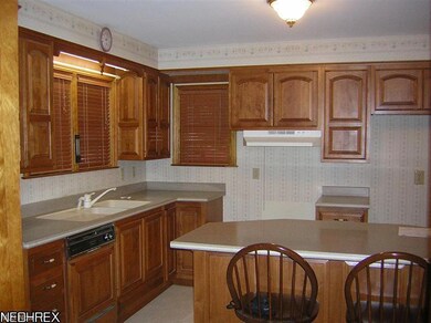Updated kitchen - cherry Cabinets by Bertch featur