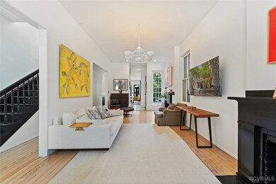 Living room with light wood-type flooring and a ch