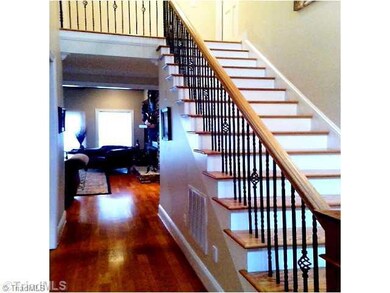 Entry. A beautiful and spacious entry will invite your guests into your home. Gleaming hardwood floors, and wrought iron railing accent the entrance.