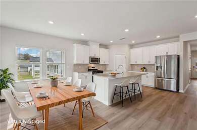 Kitchen featuring tasteful backsplash, light wood-