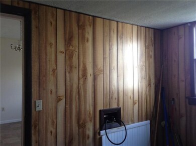 Enclosed back porch with laundry hookups.