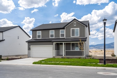 **DISCLAIMER - INTERIOR & EXTERIOR options may vary. (Grass is not included) View of front of house with covered porch, board and batten siding, concrete driveway, a front lawn, and a garage