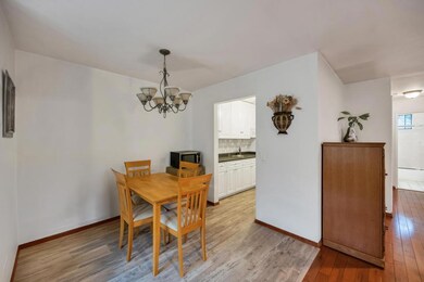 Dining room featuring light wood-type flooring, ba