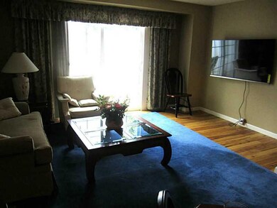 Living Room. Large living room with natural light. New sliding doors and newly finished wood floors