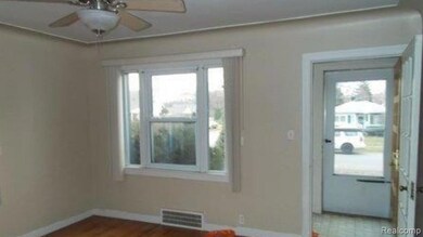 Empty room with ceiling fan and dark wood finished floors