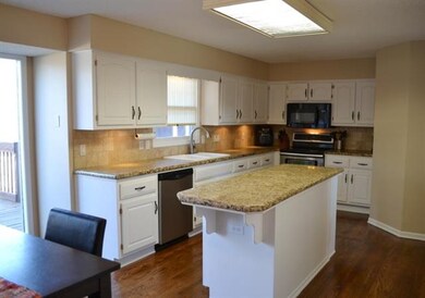 Kitchen with newly refinished hardwoods, granite c