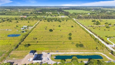 Aerial overview of property's location with rural landscape and a nearby body of water