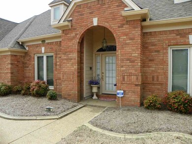 Covered front door ... note concrete edging on flo