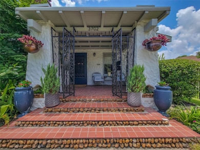 The grand porch entry is constructed of stone pill