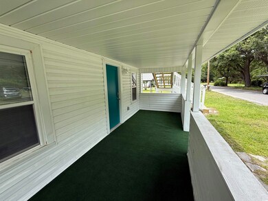 Porch featuring a yard