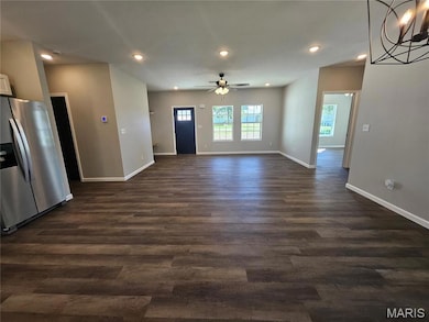 Unfurnished living room with recessed lighting, dark wood-type flooring, and a ceiling fan