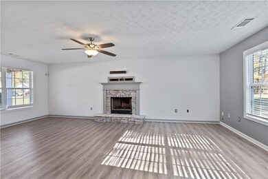 Unfurnished living room featuring a fireplace, woo