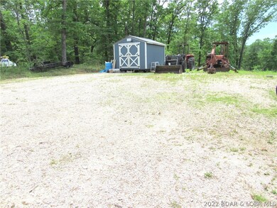 Storage shed already in place on the gravel pad.
