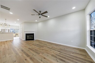living room with recessed lighting, a fireplace wi