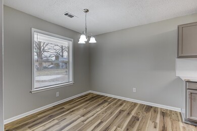 Unfurnished dining area with a textured ceiling, a