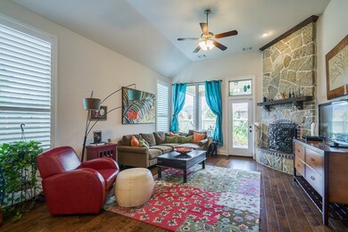 Family room with stone fireplace and lovely views of patio