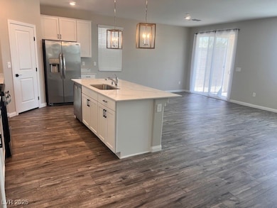 Kitchen featuring white cabinets, baseboards, stai