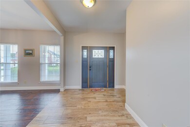 Large welcoming foyer with new front door & plank 