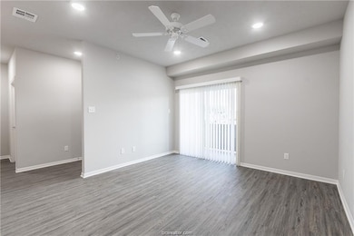 Empty room featuring wood finished floors, ceiling