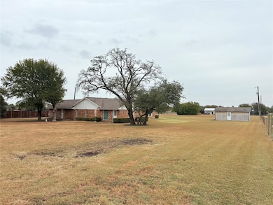 View of yard featuring a garage.