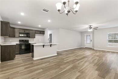 View of kitchen and den area.