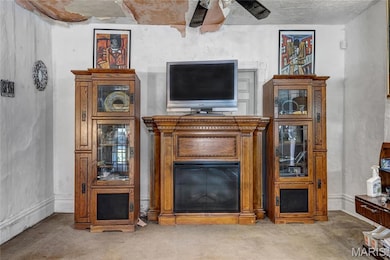 Living area featuring carpet floors and ceiling fan