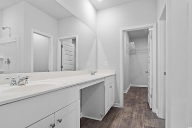 Full bathroom with wood finished floors, double va
