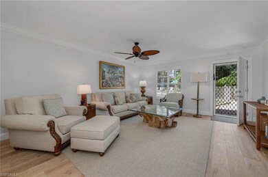 Living room featuring ceiling fan, light hardwood / wood-style floors, and ornamental molding