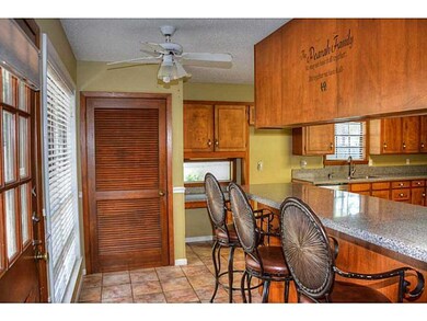 Photo. Home features a lovely bar area with stools