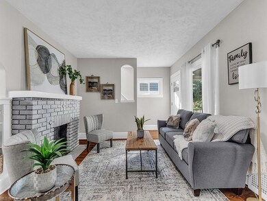 Living room with light hardwood flooring, a firepl