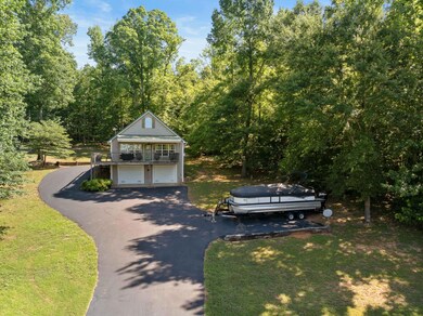 View of front of house with a garage and a front yard