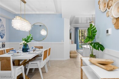 Tiled dining room with a chandelier and baseboards