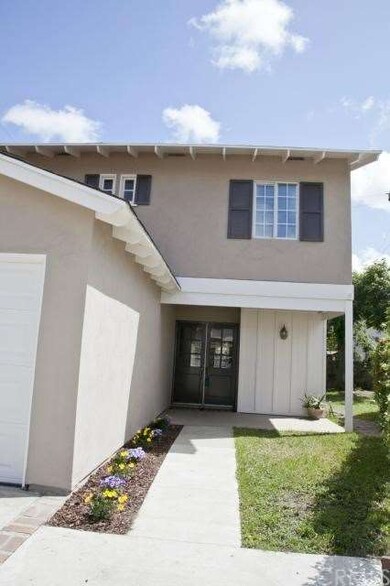 Nicely landscaped walkway welcomes you home.