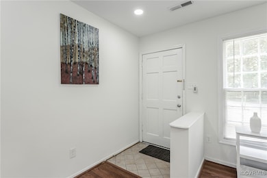 Entrance foyer featuring baseboards and recessed l