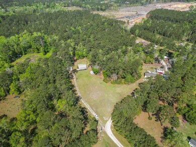 Aerial view featuring a wooded view
