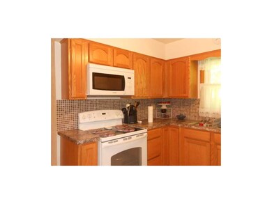Kitchen. Updated cabinets, counter, flooring, back