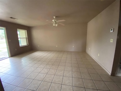 Spare room with a ceiling fan, visible vents, and 