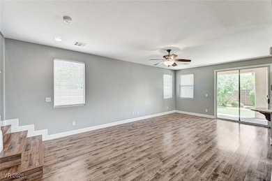 Spare room with wood finished floors, a ceiling fa