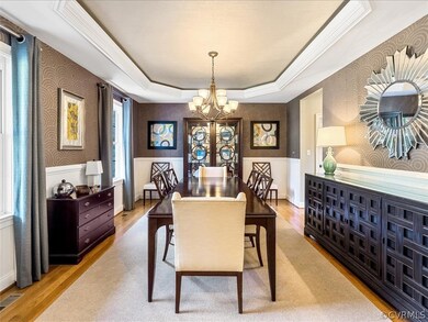 Dining room with tray ceiling and wainscoting