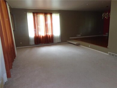 living room with step up to dining room