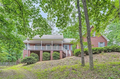 Rear view of property featuring brick siding and stairs