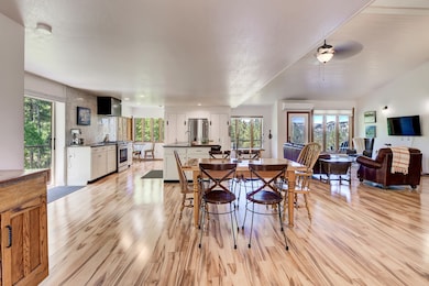 Dining space featuring light wood-type flooring, healthy amount of natural light, and ceiling fan