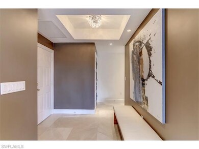 Sophisticated foyer with crystal chandelier sets t