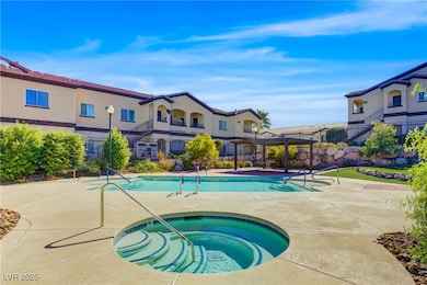 Community pool featuring a hot tub, a patio area, a pergola, and a balcony